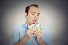 Closeup portrait greedy banker, CEO boss, corporate employee, crazy guy, funny looking man obsessed, licking cash, money, dollars with tongue, isolated grey wall background. Face expression emotion