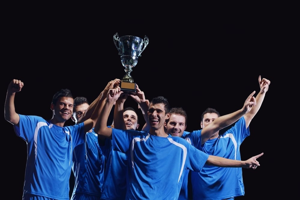 soccer players team group celebrating the victory and become champion of game while holding win coup